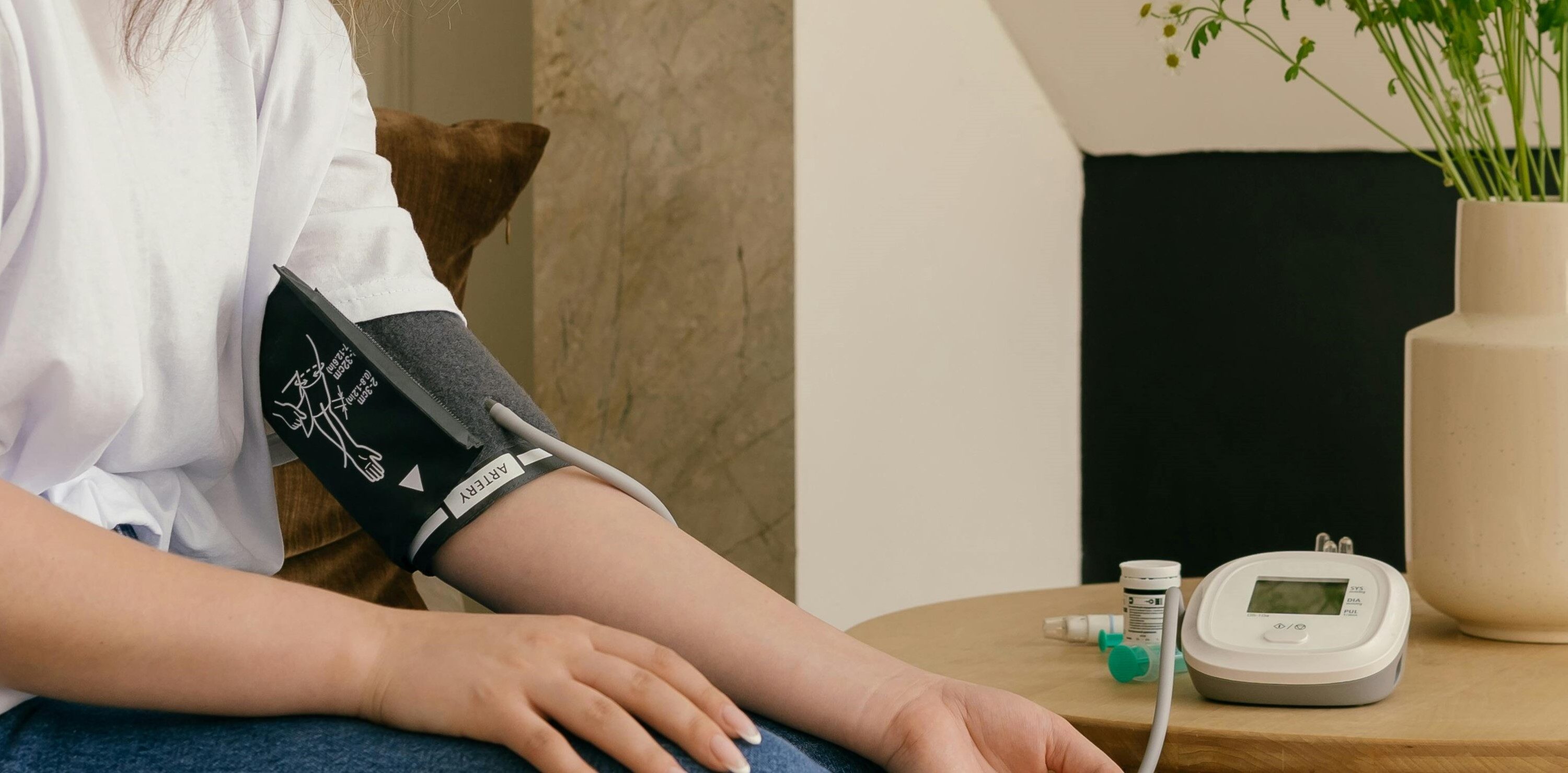 Woman using blood pressure machine