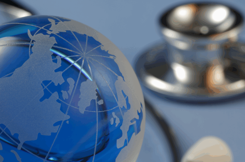A close-up image of a glass globe, symbolising global healthcare, with a stethoscope in the background. The image conveys international medical collaboration, representing a World Health Organisation doctor visiting HCL to observe integrated care practices.